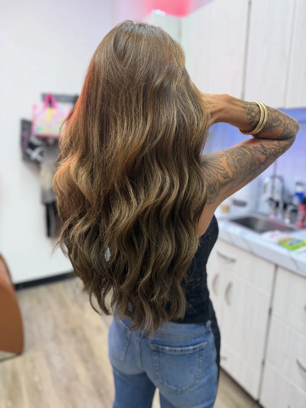 Hand-painted caramel balayage falling in loose waves