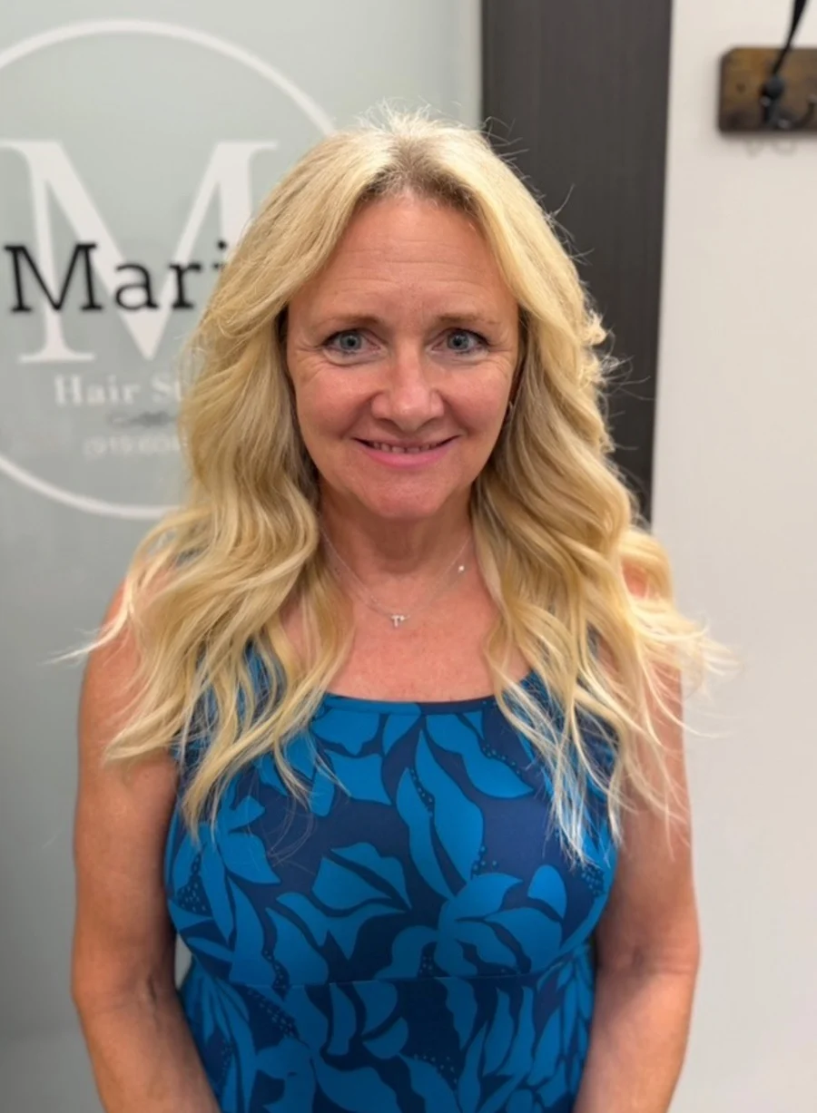 Long, full blonde waves after a sewn-in weft install